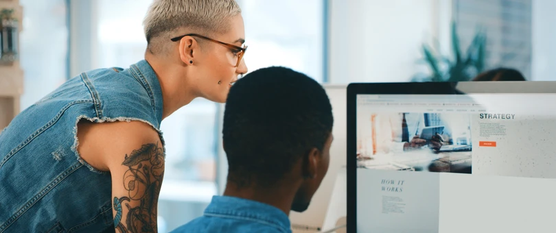 girl and guy looking at a computer monitor