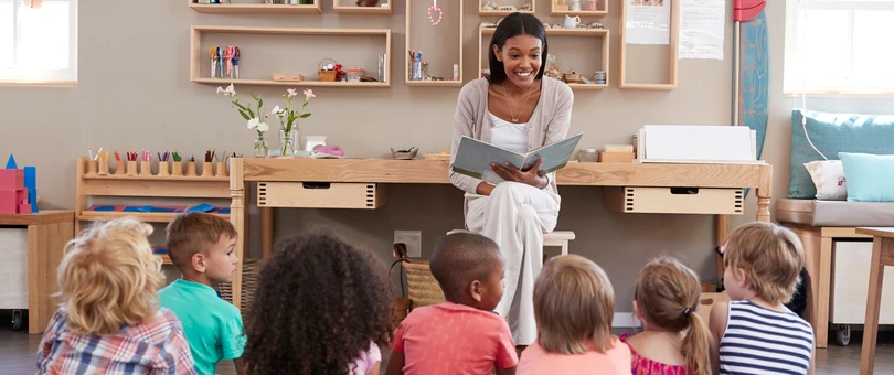 woman reading to small children in a classroom